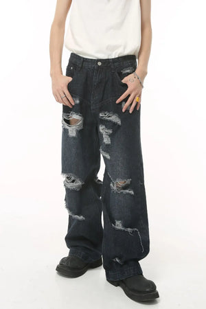 Distressed baggy dark denim jeans with statement rips and a comfortable cotton feel.