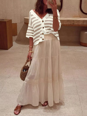 Cropped striped knit cardigan with buttons and V-neck, styled with a maxi skirt.