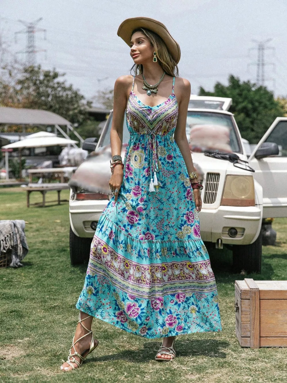 Floral tiered cami maxi dress with tassels and a drawstring waist.