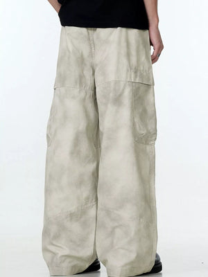 Relaxed fit beige cargo pants with multiple pockets and a wide leg.