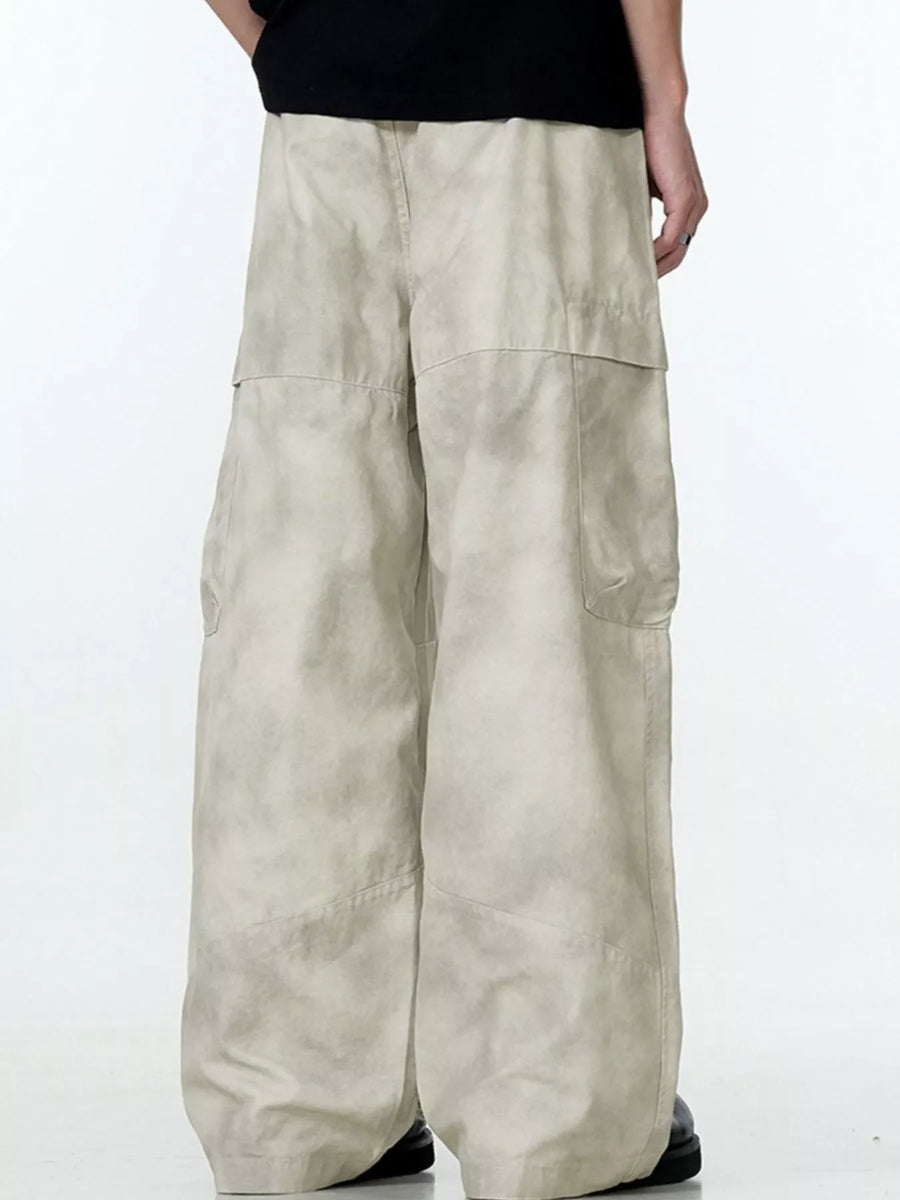 Relaxed fit beige cargo pants with multiple pockets and a wide leg.