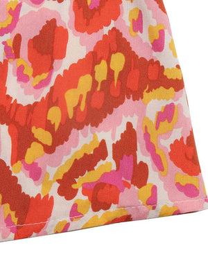 Abstract print maxi dress in pink, red, orange, and yellow.