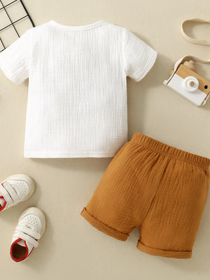 Children's white cotton gauze top and brown shorts set, casual comfortable outfit.