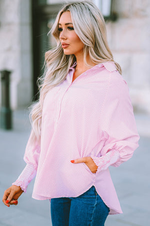 Blush pink pinstripe blouse with balloon sleeves and smocked cuffs, styled with jeans.