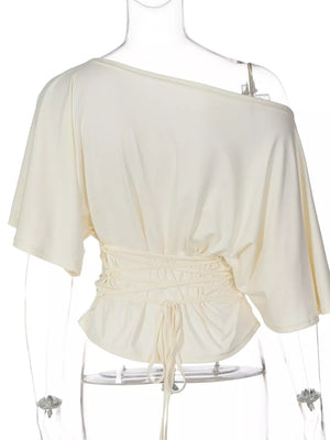 Apricot draped tie-front short sleeve t-shirt with dolman sleeves and a cinched waist.