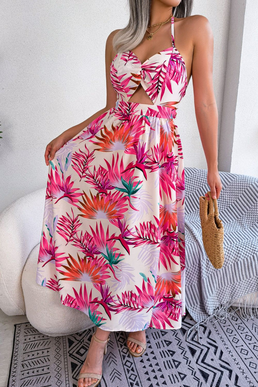 Tropical halter maxi dress with cutout and botanical print.