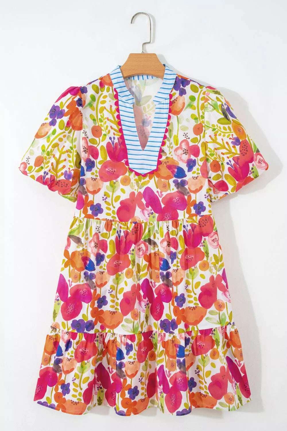Vibrant floral cotton mini dress with tiered skirt and blue striped V-neck.