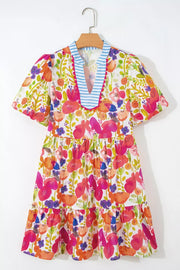 Vibrant floral cotton mini dress with tiered skirt and blue striped V-neck.