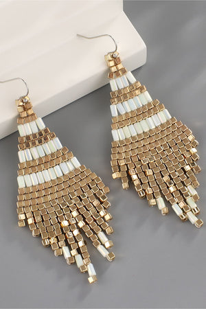 Geometric beaded fringe earrings with gold and white beads.