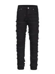 Black denim jeans with layered frayed detailing and a sculpted fit.