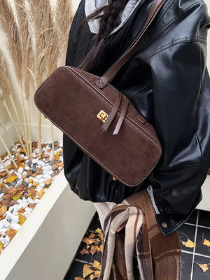 Brown suede shoulder bag with gold clasp detail and leather strap