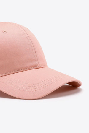Blush pink cotton twill baseball cap with curved brim and stitched details.