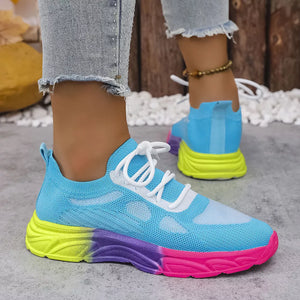 Breathable mesh lace-up sneakers in sky blue with a vibrant gradient sole in yellow, purple, and pink.