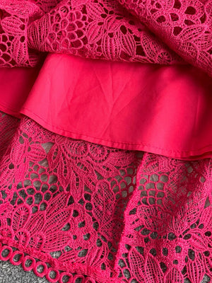 Fuchsia pink lace A-line dress with floral cutout detail and scalloped hem.