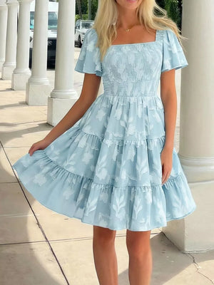 Light blue smocked mini dress with tiered skirt and floral pattern