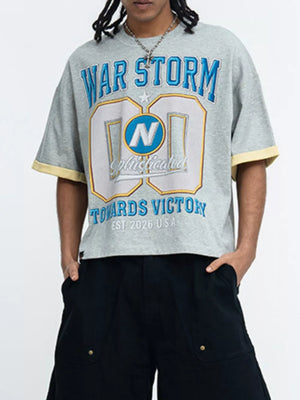 Grey graphic t-shirt with blue and yellow text, crew neck, short sleeves, and yellow trim.