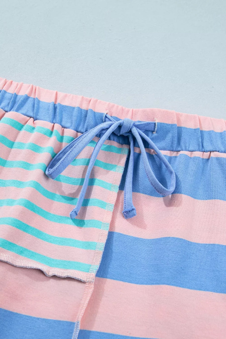 Striped shorts in pink, blue, and teal with a drawstring waist