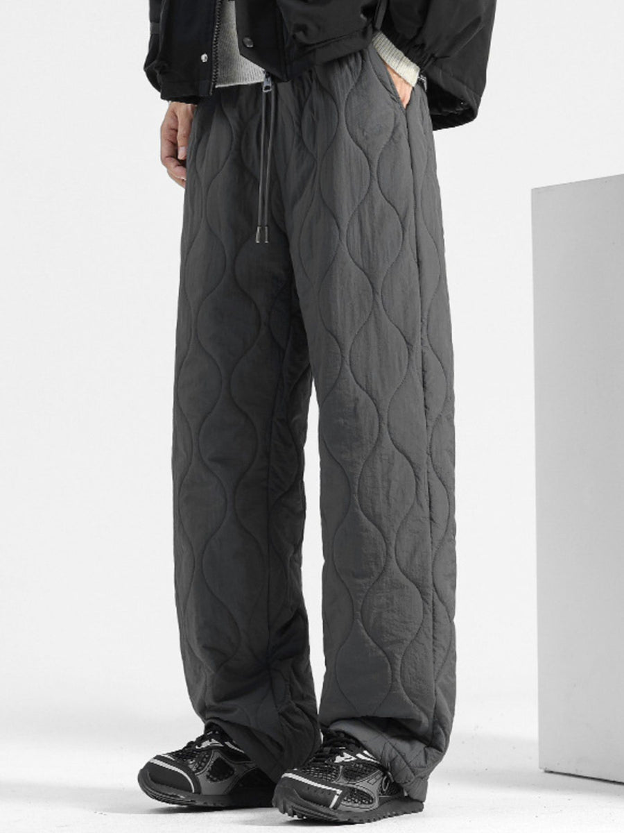 Men's dark gray quilted sweatpants with relaxed fit and drawstring waist.