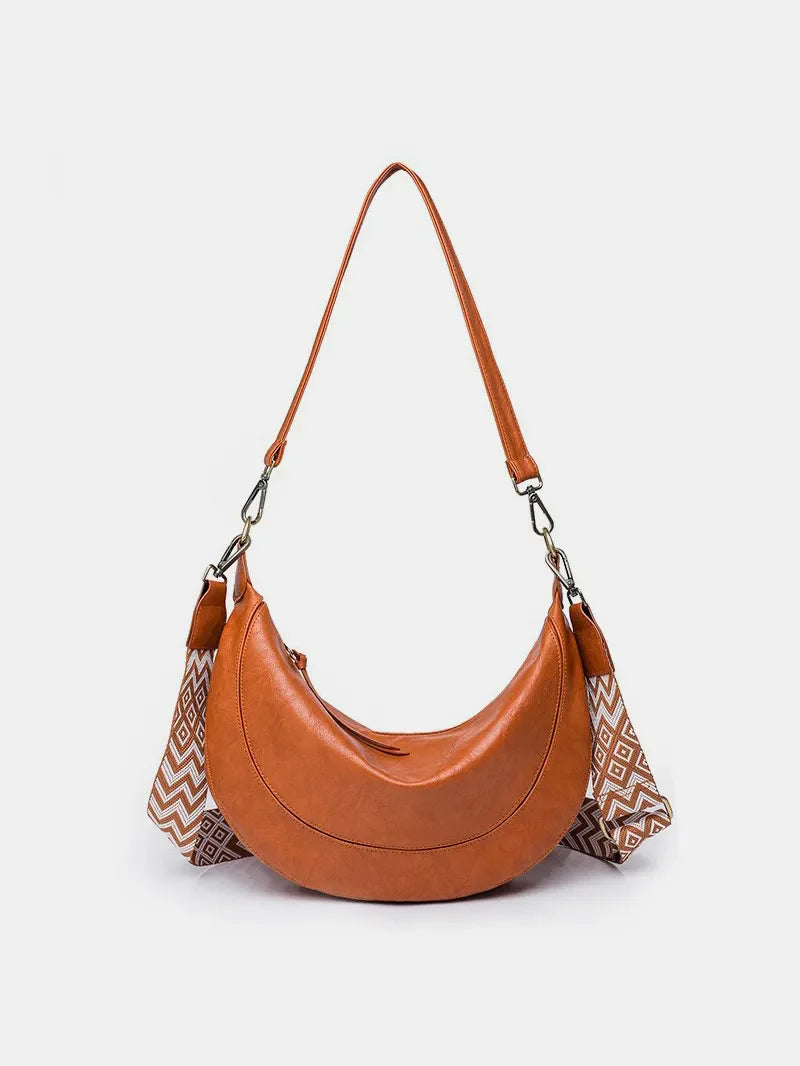 Terracotta leather crescent crossbody bag with geometric strap