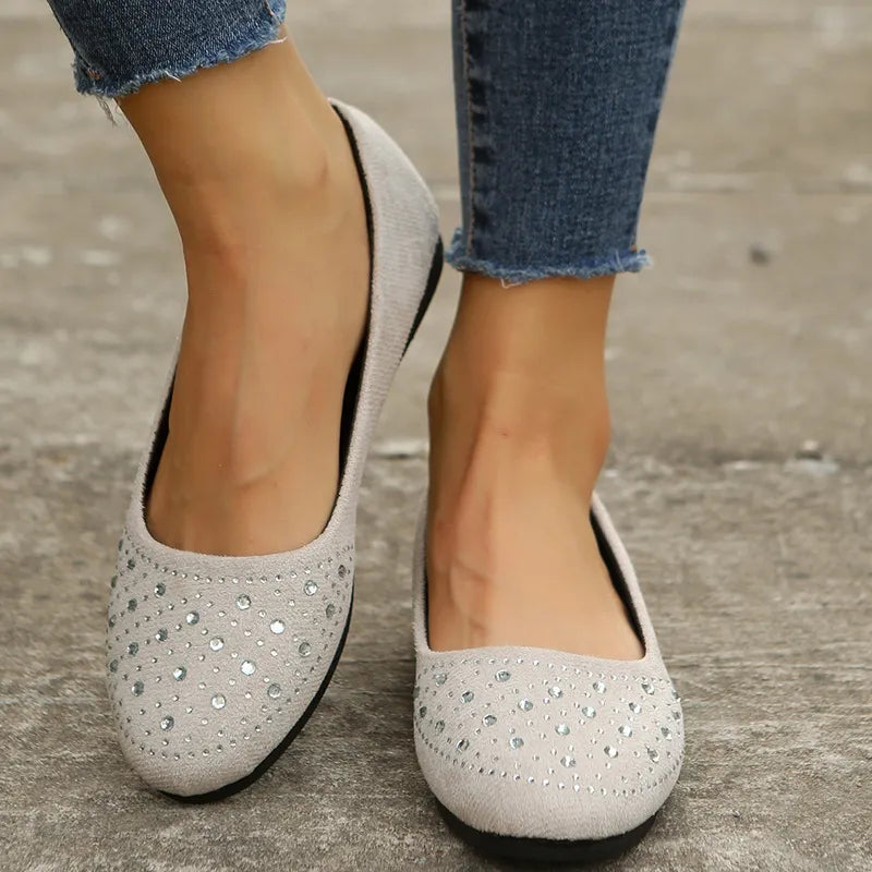 Beige embellished suede ballet flats with crystal details.