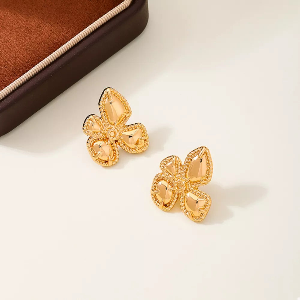 earrings in gold featuring flower design and jewelry fit