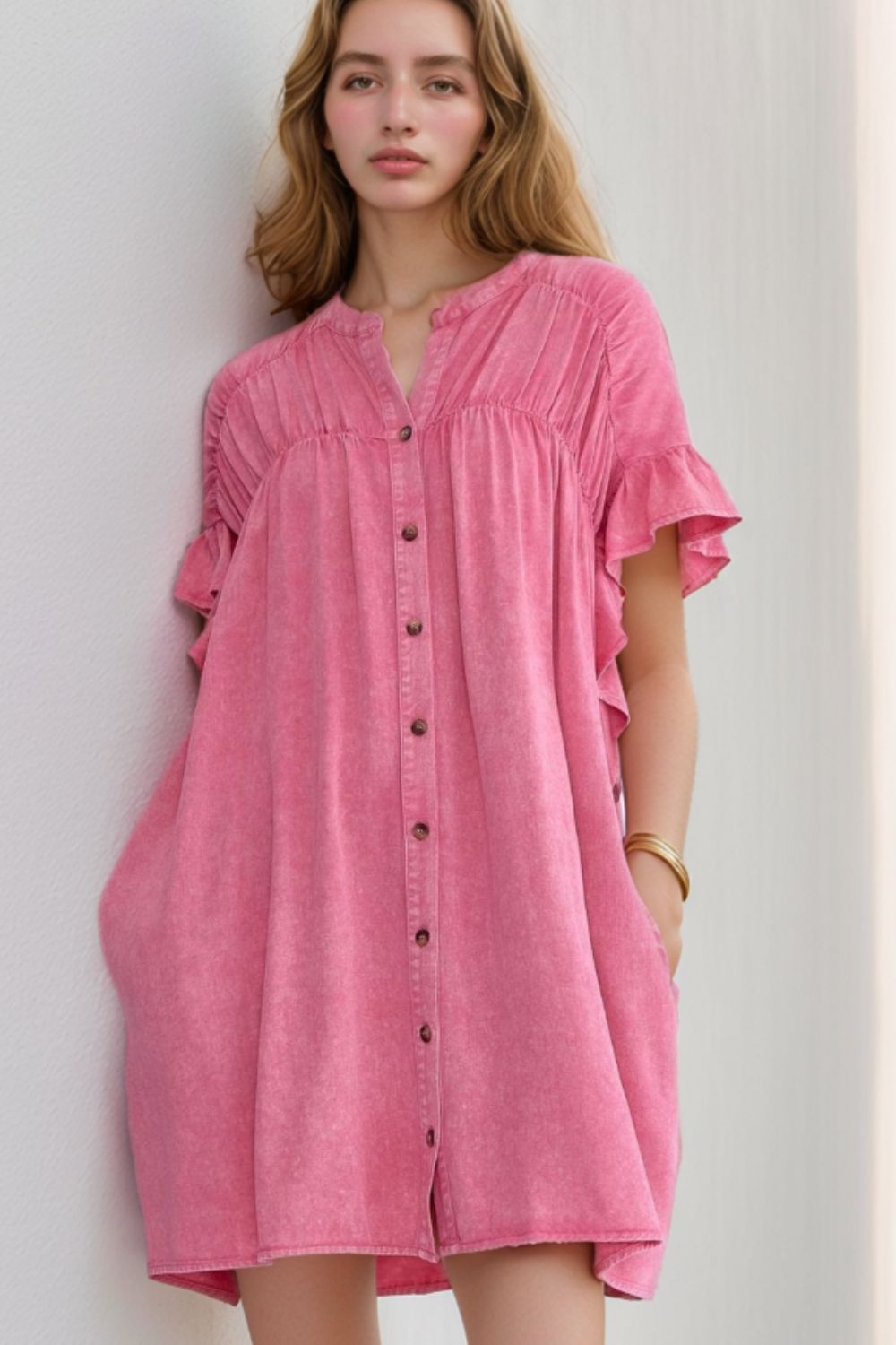 Acid wash pink buttoned shirt dress with ruffled sleeves and cinched bodice.