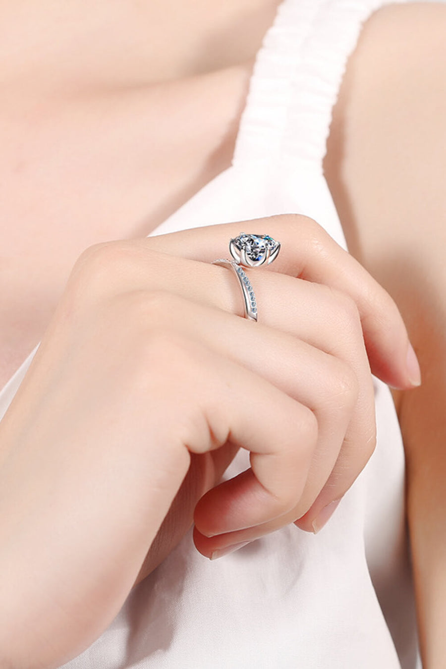 Silver bypass ring with pavé-set band and solitaire bloom center stone.