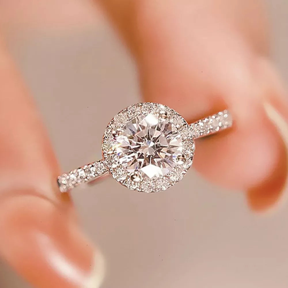 ring in silver featuring halo setting and straight fit