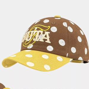 Brown polka dot baseball cap with yellow brim and embroidered text.