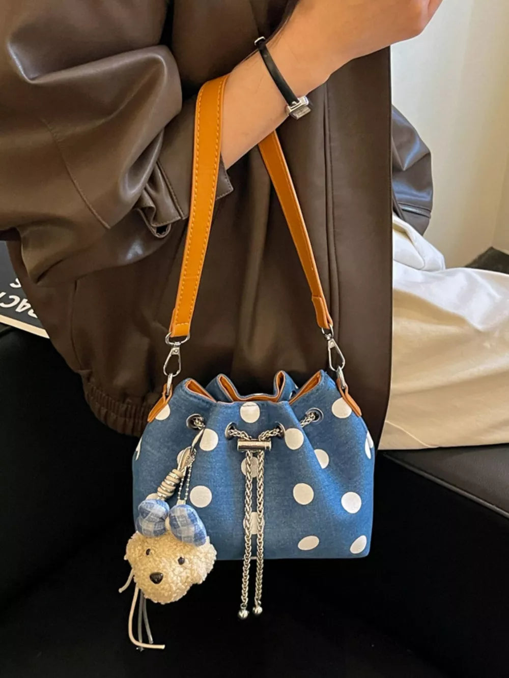 crossbody bag in denim blue featuring adjustable strap and bucket fit
