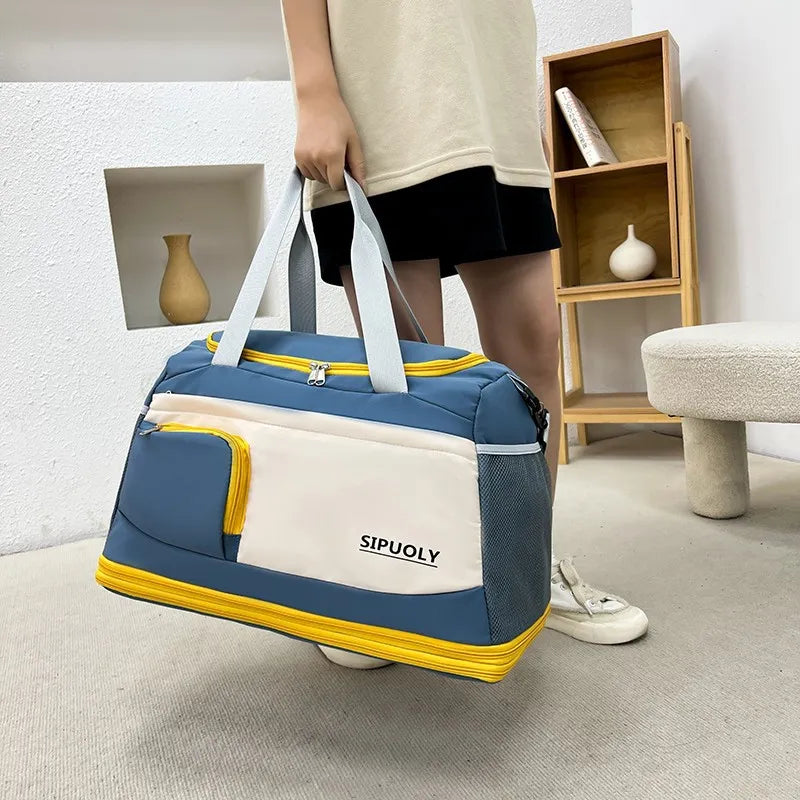Utility duffel bag in blue, cream, and yellow with multiple zippered pockets and mesh side panels.