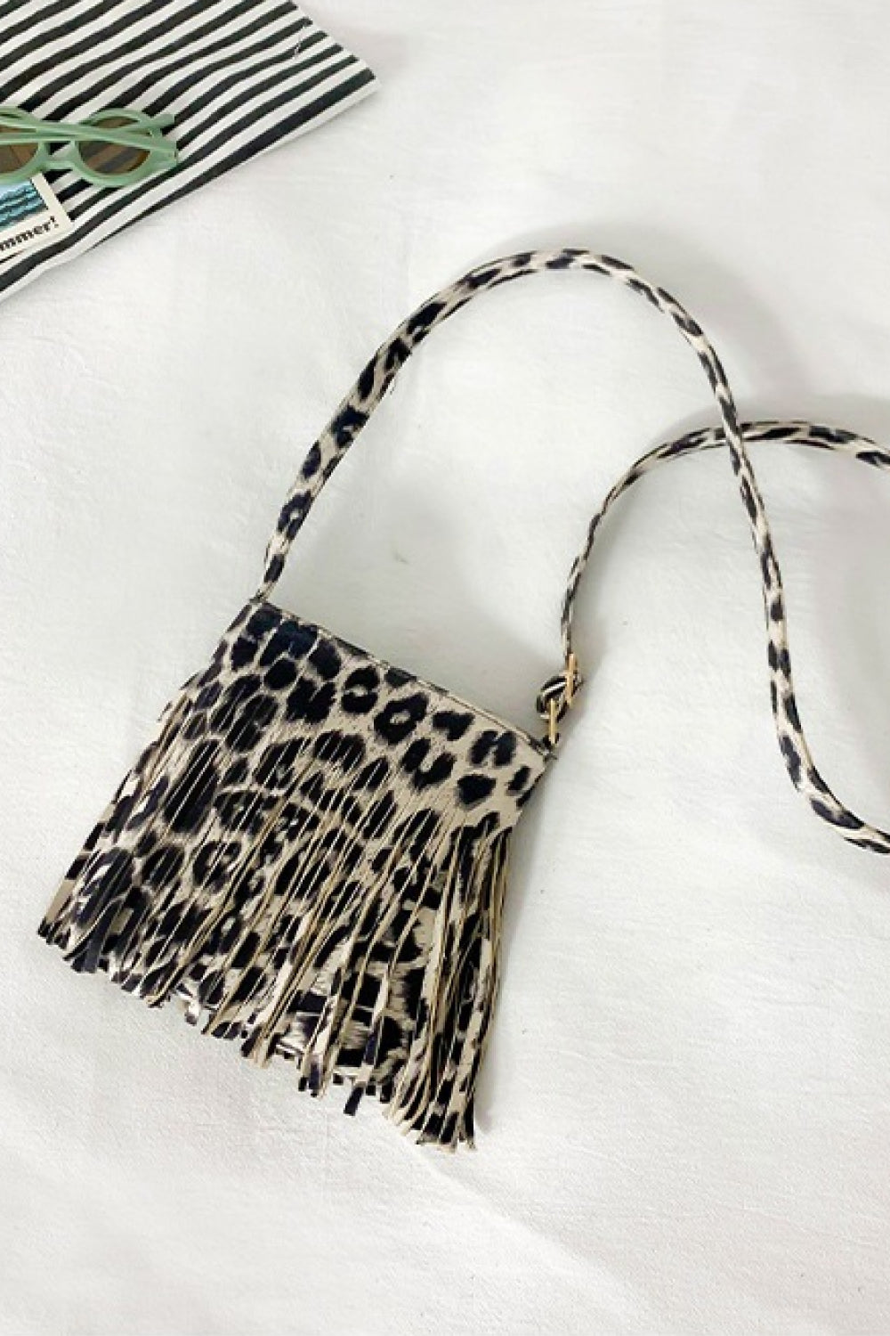 Leopard print crossbody bag with fringe detail and adjustable strap