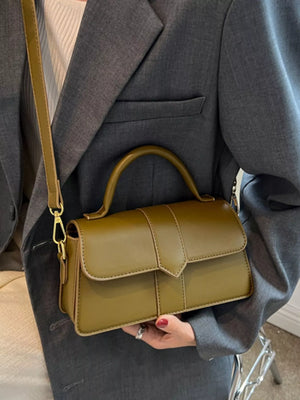 Chic small top handle bag in green with a classic flap closure and top handle.