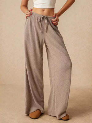 Effortless wide-leg drawstring pants in beige ribbed knit with a relaxed fit.