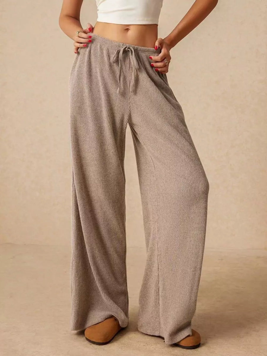 Effortless wide-leg drawstring pants in beige ribbed knit with a relaxed fit.