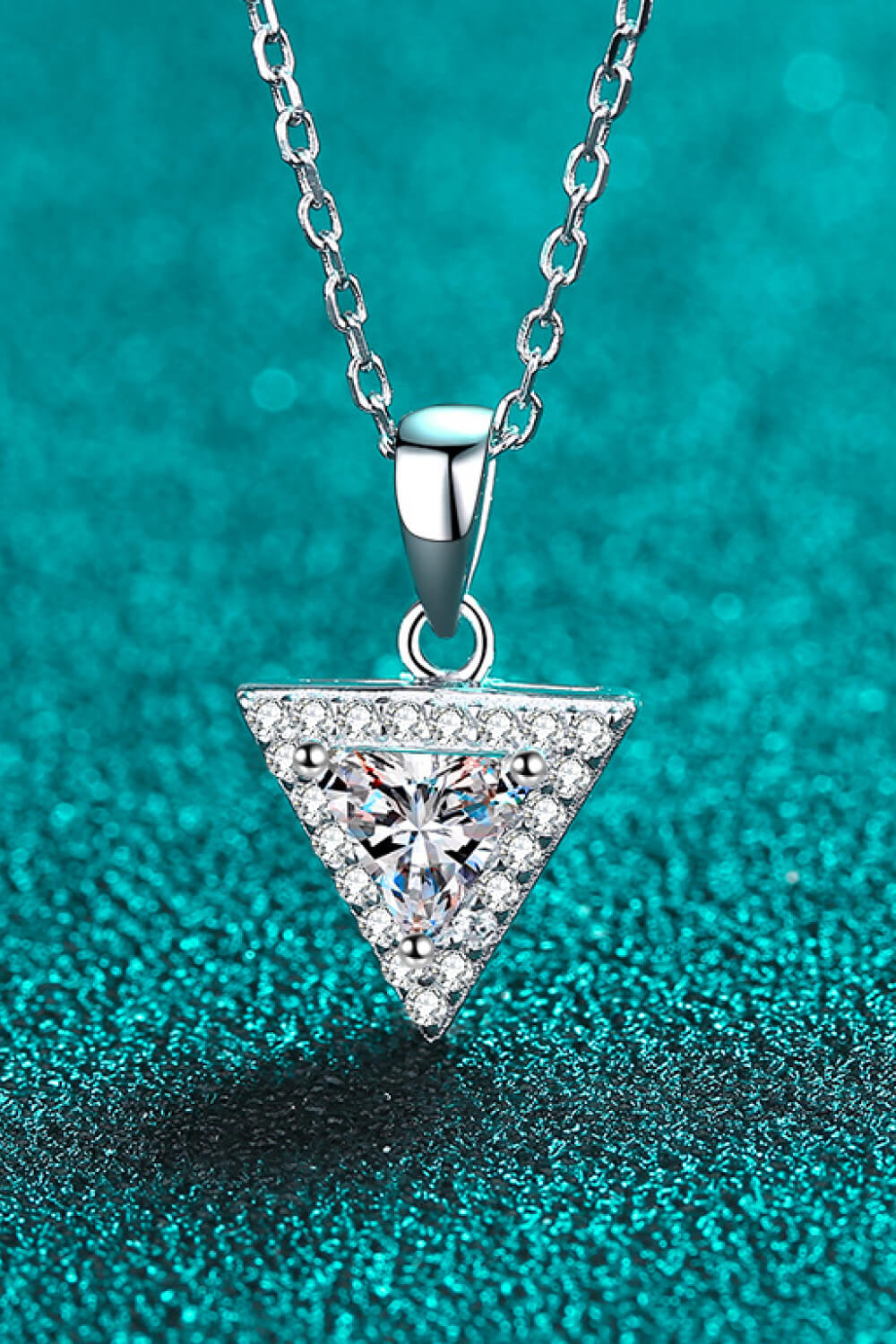 Geometric halo moissanite necklace in silver with a triangle pendant and clear stones.