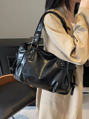 Large black vintage PU leather shoulder bag with silver hardware and top handles.