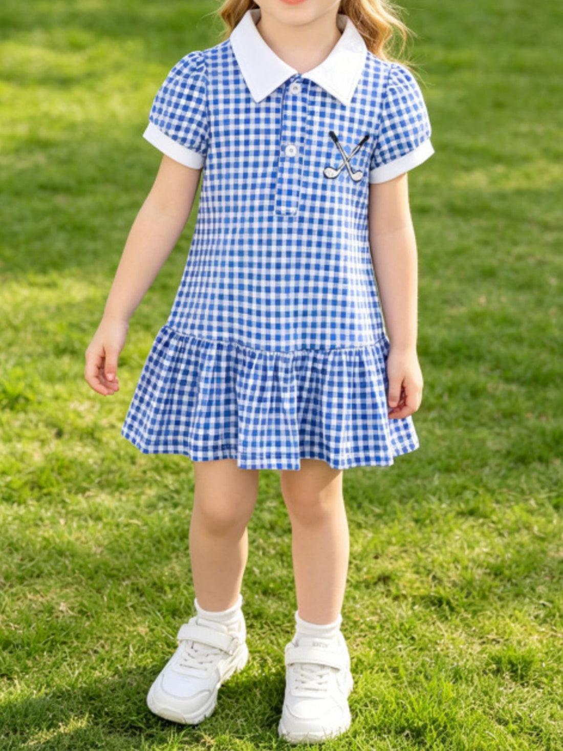 Baby dress with blue gingham, white polo collar, short sleeves, and ruffled hem.