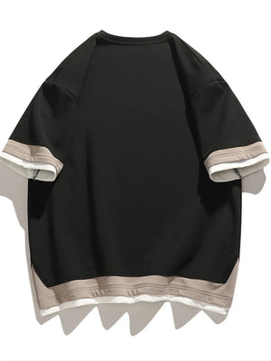 Black cotton blend t-shirt with layered taupe and white trim on sleeves and hem.