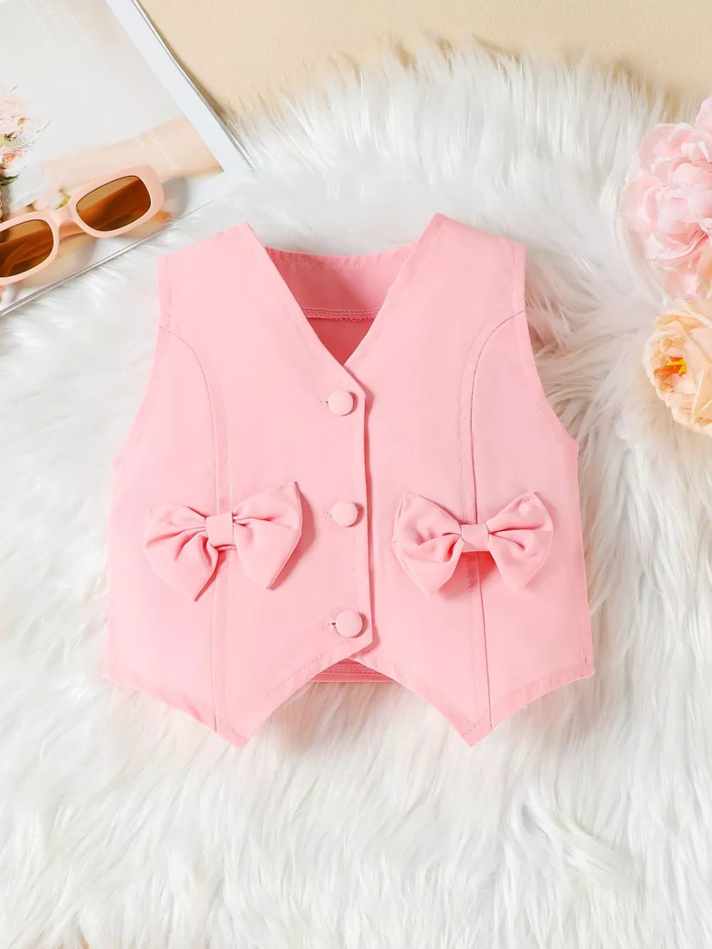 Pink baby vest with two bowknot details and button closure