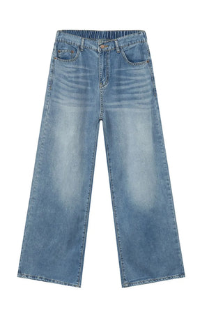 Oversized baggy denim trousers in medium wash with elastic waistband and wide legs.