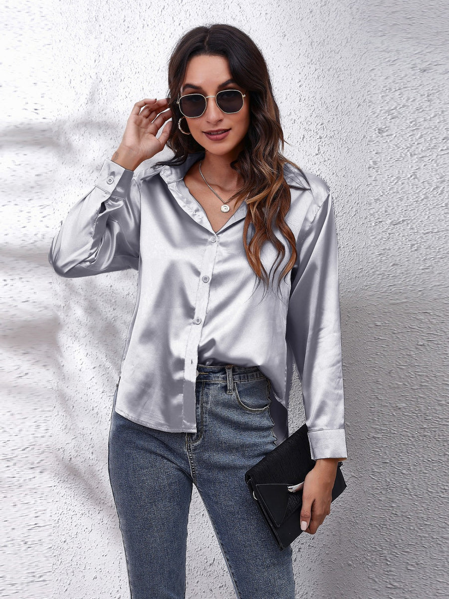 Silver satin finish button-up shirt with effortless drape, collared neckline, and button cuffs.