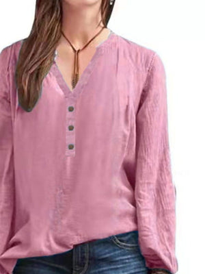 Pink long-sleeve blouse with notched neckline and button detail
