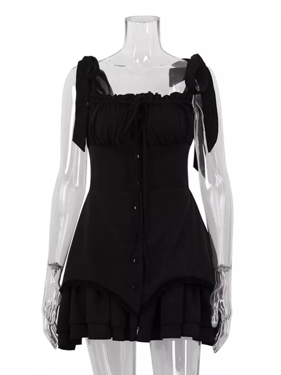 Black mini dress with tie straps, square neckline, ruffled trim, and button front.