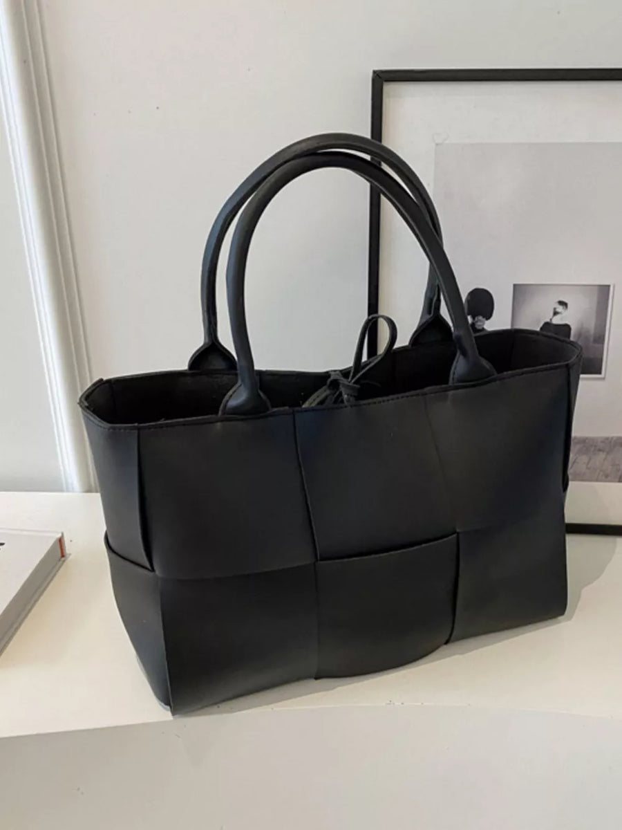 Black woven PU leather large tote bag with double handles and tie closure.