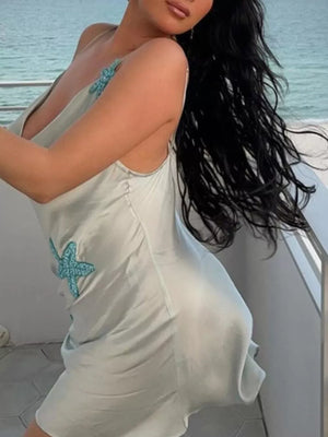 Light blue satin slip dress with beaded starfish embellishments and spaghetti straps