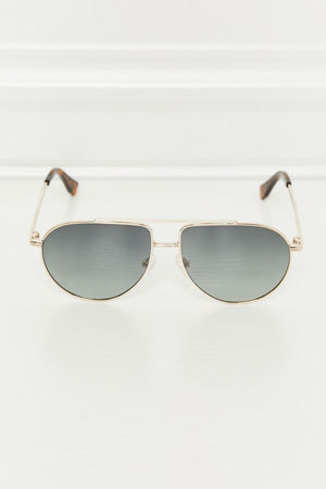 Gradient lens aviator sunglasses with a gold metal frame and tortoise shell temple tips.