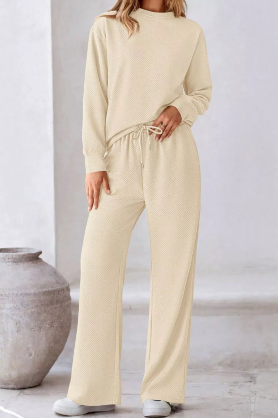 Apricot textured loungewear set with drawstring pants and crewneck sweatshirt.