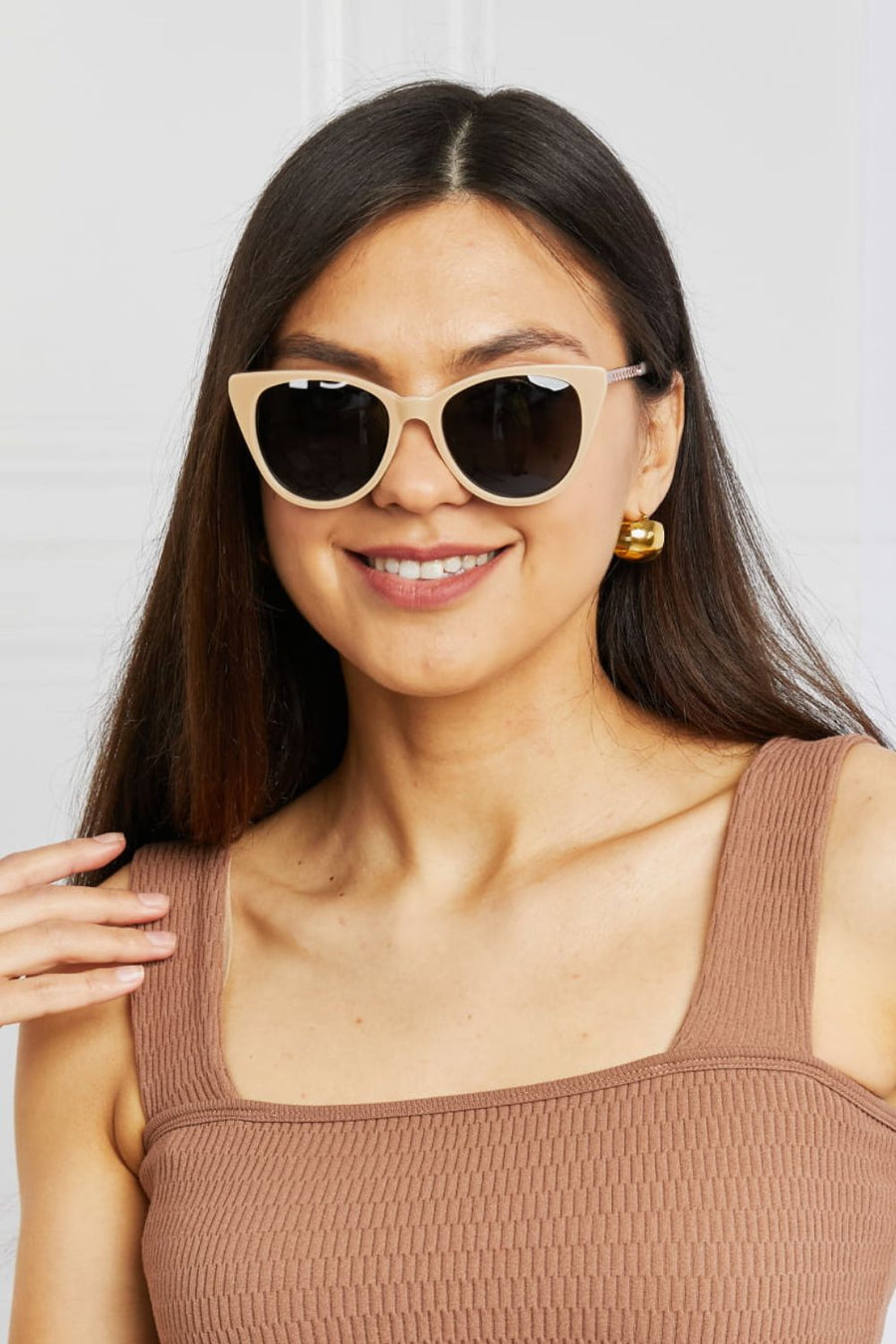 Cat-eye acetate sunglasses in mocha with chain detail and dark lenses.