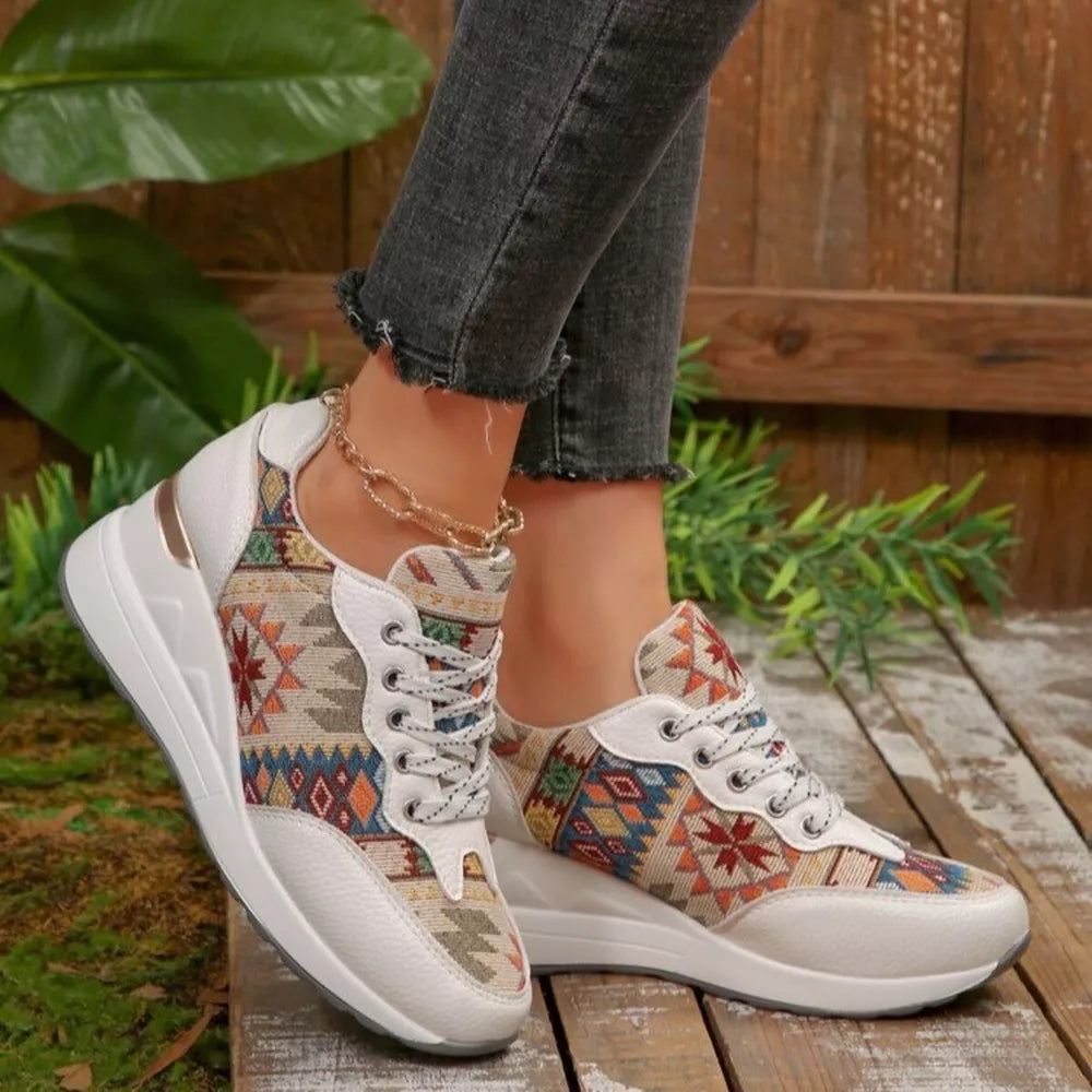White wedge sneakers with geometric pattern and lace-up closure